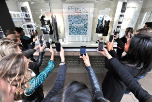 people using qr codes to scan a marketing advertisement. a great marketing tool to use.